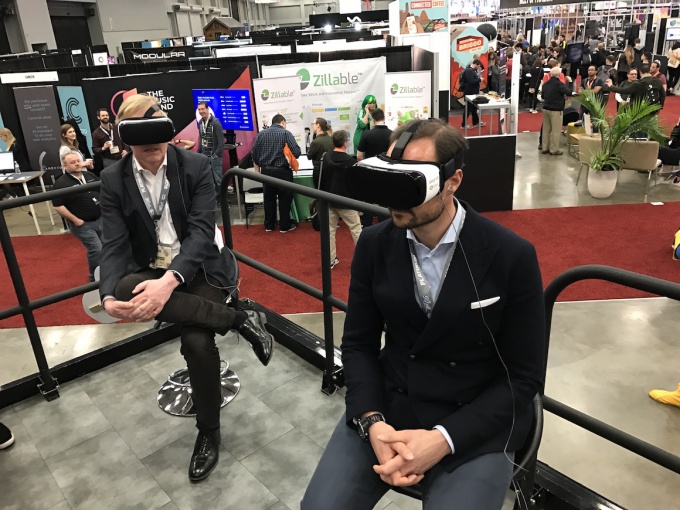 Crown Prince Haakon and the Norwegian ambassador tries out VR at the tech fair. Photo: Christian Lagaard, The Royal Court.